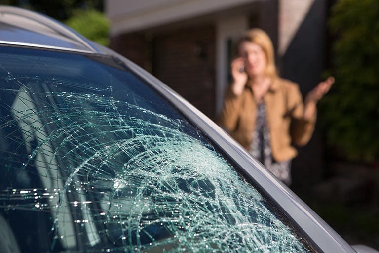 Woman Phoning For Help After Car Windshield Has Broken Woman Phoning For Help After Car Windshield Has Broken